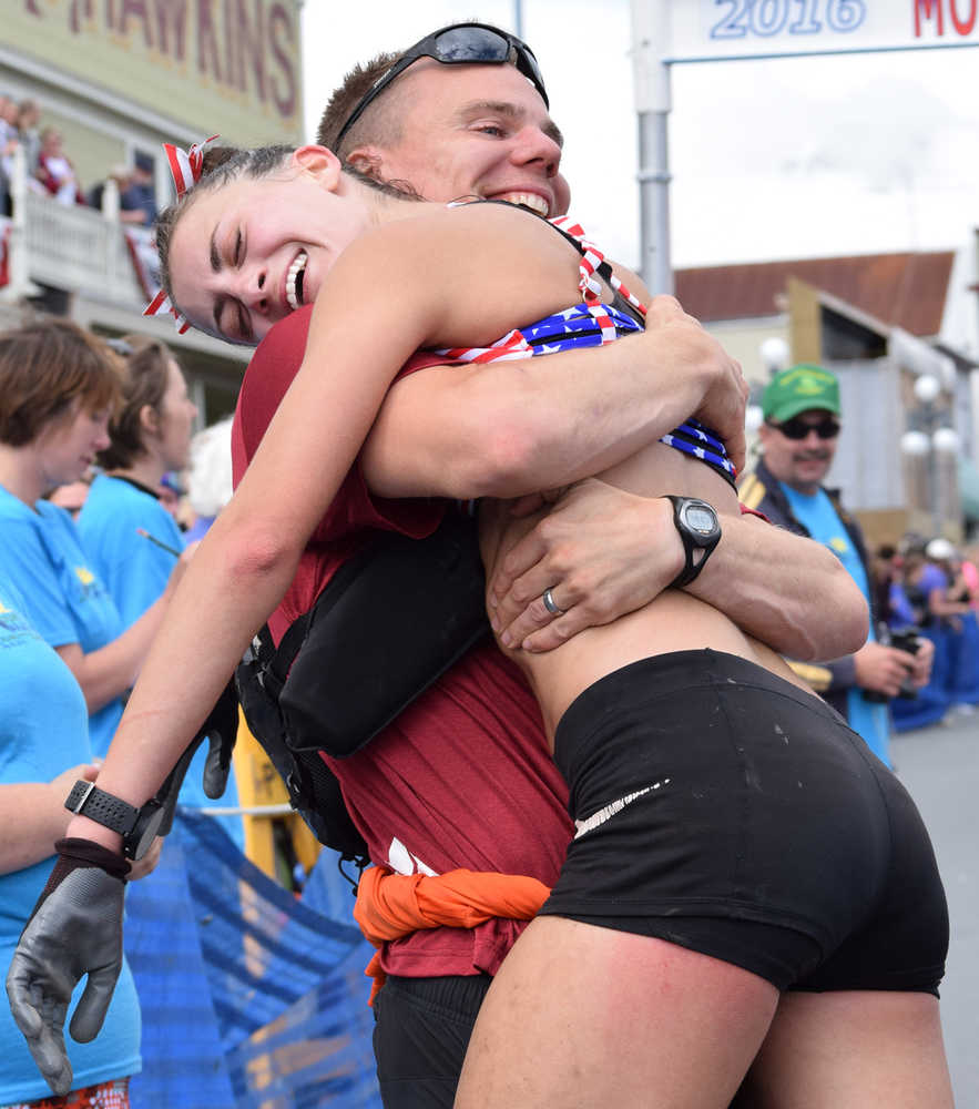Photo by Jeff Helminiak/Peninsula Clarion Eric Strabel congratulates his wife, Denali Foldager-Strabel, on her third-place finish Monday at the women's Mount Marathon race in Seward.