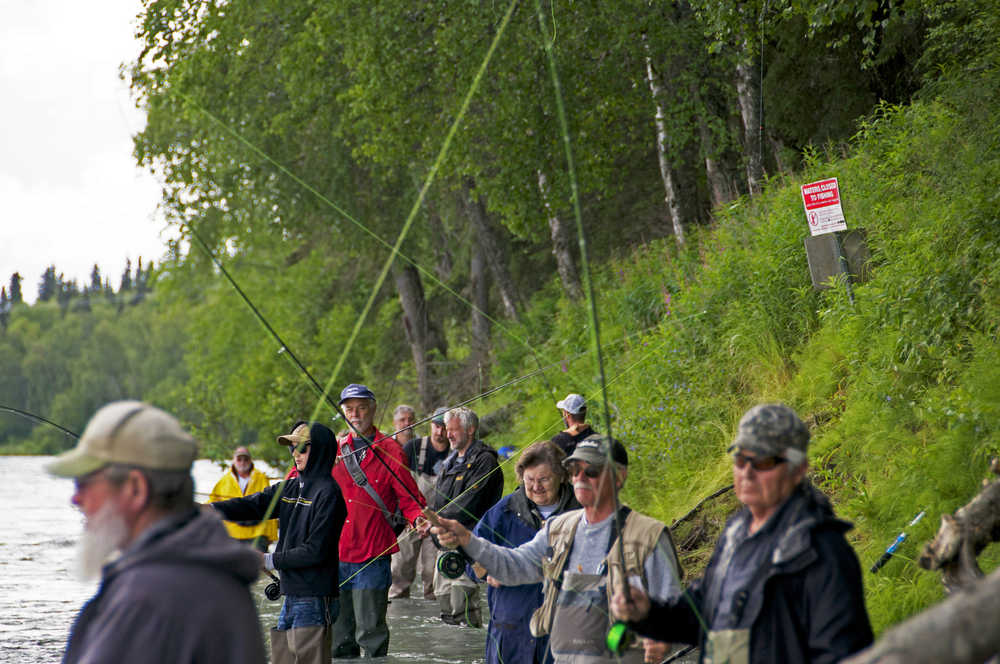 Photo by Elizabeth Earl/Peninsula Clarion Anglers line the banks of the Kenai River near the Donald E. Gilman River Center in Soldotna, Alaska on Thursday, July 7, 2016. Many reported good fishing for sockeye salmon that day in the river.