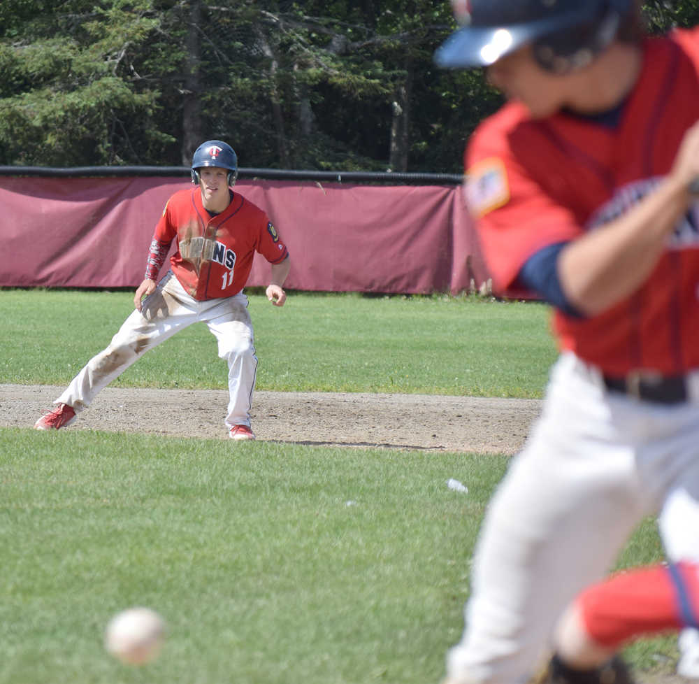 Photo by Joey Klecka/Peninsula Clarion Post 20 Twins Paul Steffensen keeps an eye on the ball while teammate Josh Darrow bats against Tennessee Post 19 in Thursday's championship game of the Bill Miller Big Fish Wood Bat tournament at the Kenai Little League fields.