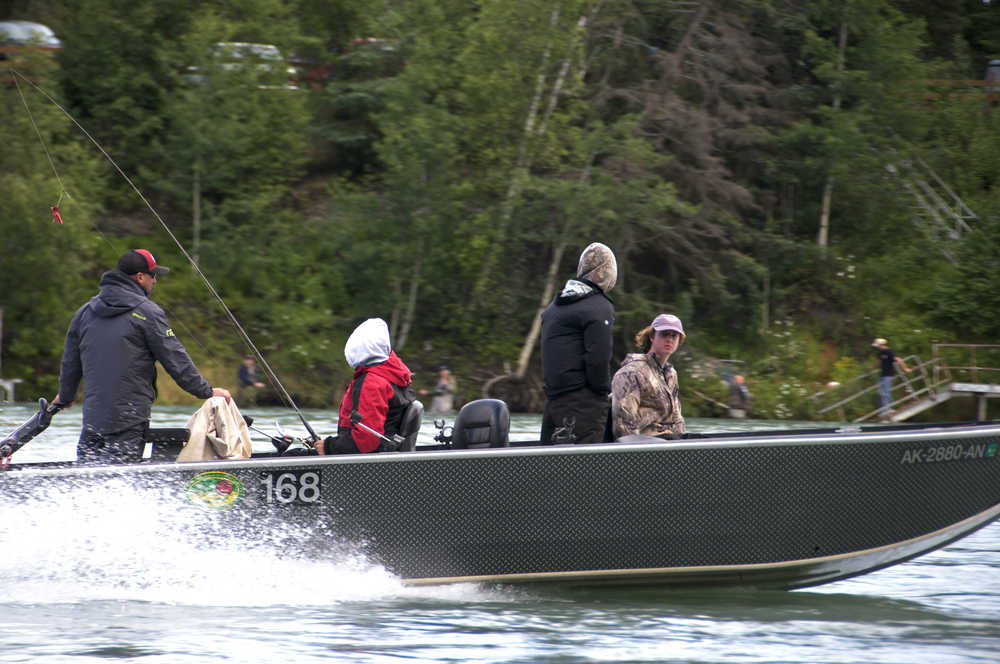 Photo by Elizabeth Earl/Peninsula Clarion A guide boat motors along the Kenai River upstream of the Sterling Highway Bridge in Soldotna, Alaska on Thursday, July 7, 2016.