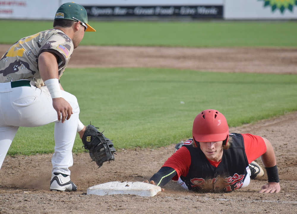 Photo by Joey Klecka/Peninsula Clarion Brody Wofford of the Peninsula Oilers tags first base beyond the outstretched glove of Mat-Su Miners' baseman Jake Scudder Saturday evening at Coral Seymour Memorial Park in Kenai.