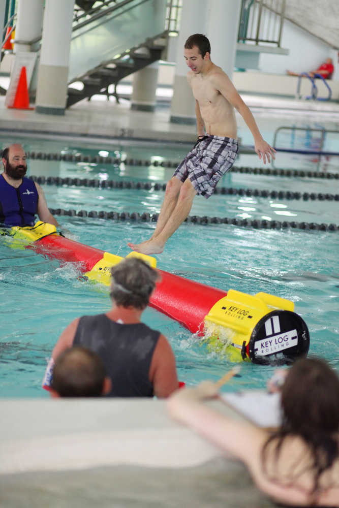 Photo by Kelly Sullivan/ Peninsula Clarion Jeremy Ruggiero properly falls off the Key Log during a timed roll Monday, July 11, 2016, at the Nikiski Pool in Nikiski, Alaska.