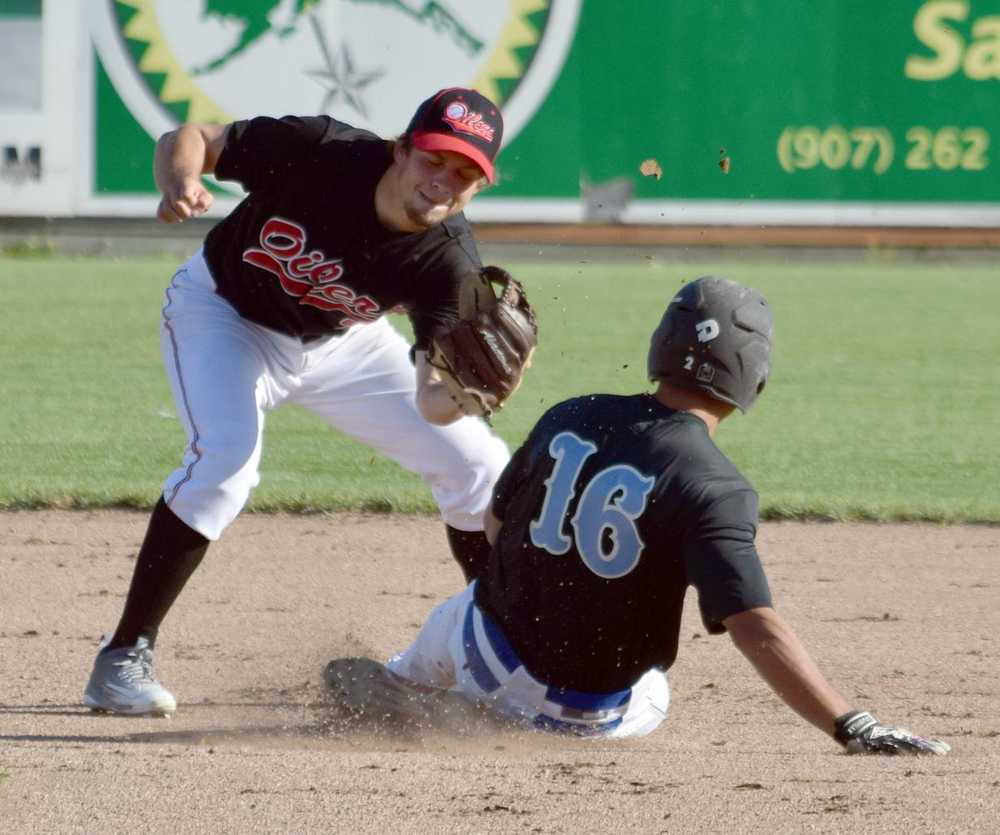 Photo by Jeff Helminiak/Peninsula Clarion Oilers second baseman Jake Darrow tags out a stealing Jonathan Segovia on Tuesday at Coral Seymour Memorial Park in Kenai.