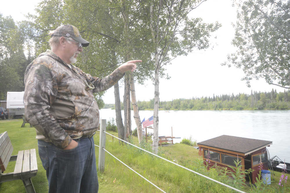 Photo by Megan Pacer/Peninsula Clarion Albera, Canada resident Doug Bangle, pictured Wednesday, July 13, 2016, points out the spot on the Kenai River where he and his son, Ryan, pulled out a 15-year-old girl who had fallen in early Tuesday morning. She was rescued when the men got into their boat after hearing her cries for help from their campsite at the Iva's Place RV Park on Knight Drive in Soldotna, Alaska.