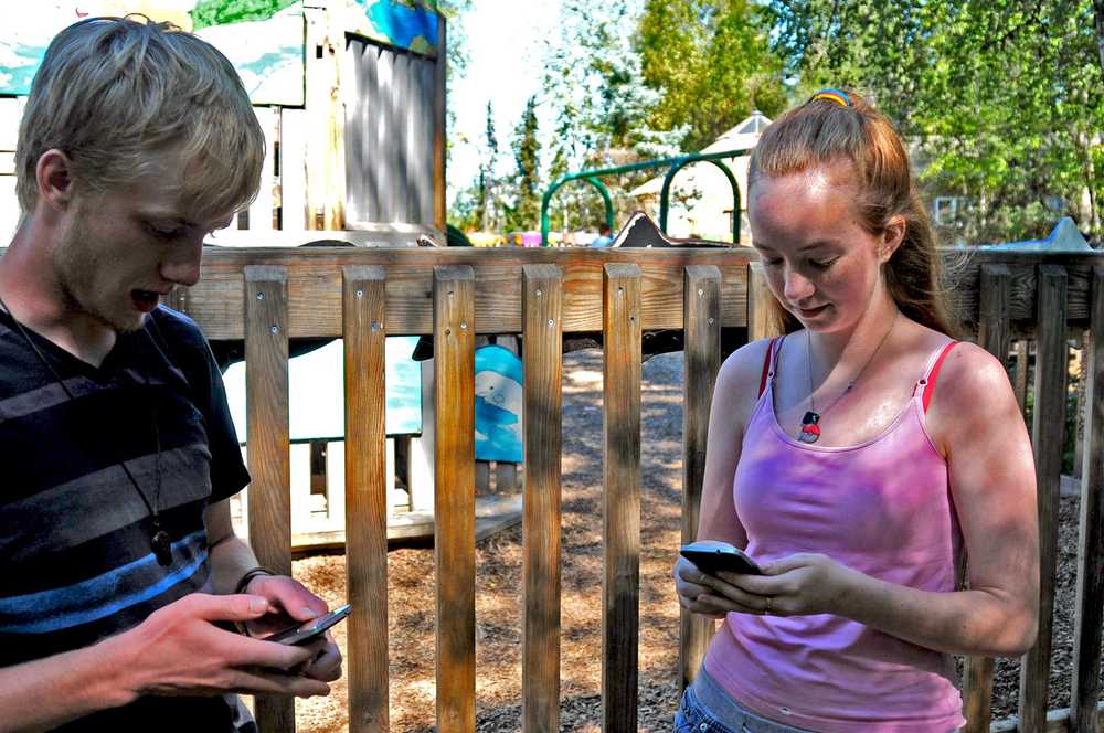 Photo by Elizabeth Earl/Peninsula Clarion Keenan Orth (left) and his sister Ginni Orth (right) train Pokemon on the app Pokemon Go in Soldotna Creek Park in Soldotna, Alaska, on Friday, July 15, 2016. Since the smartphone-based game premiered July 6, millions of players have signed up worldwide.
