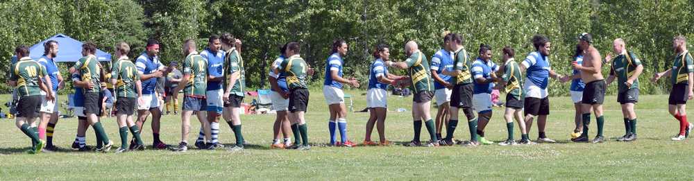 Photo by Jeff Helminiak/Peninsula Clarion Members of the Kenai River Wolfpack (in green) and the Manu Bears share postgame handshakes and hugs at the Kenai Dipnet Fest Rugby 10s Tournament on Saturday in Kenai.