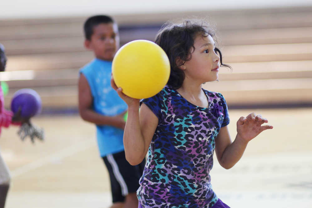Photo by Kelly Sullivan/ Peninsula Clarion Coralyn Maynard prepares to chuck a dodgeball at her opponents Thursday, July 14, 2016 at the Kenai Boys and Girls Club clubhouse in Kenai, Alaska.