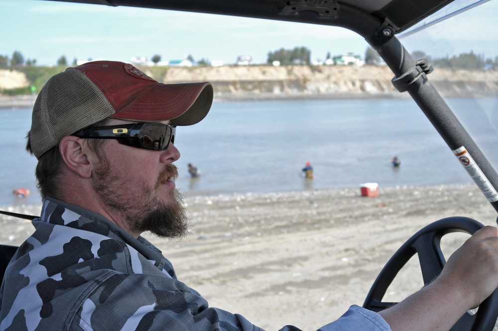 Photo by Elizabeth Earl/Peninsula Clarion Jason Floyd, the owner of Ammo Can Coffee, drives a side-by-side on the south beach of the Kenai River on Monday, July 18, 2016 in Kenai, Alaska. Floyd parked a trailer serving coffee near the entrance to the personal use dipnet fishery and makes delivery runs along the beach, selling ice and taking coffee orders.