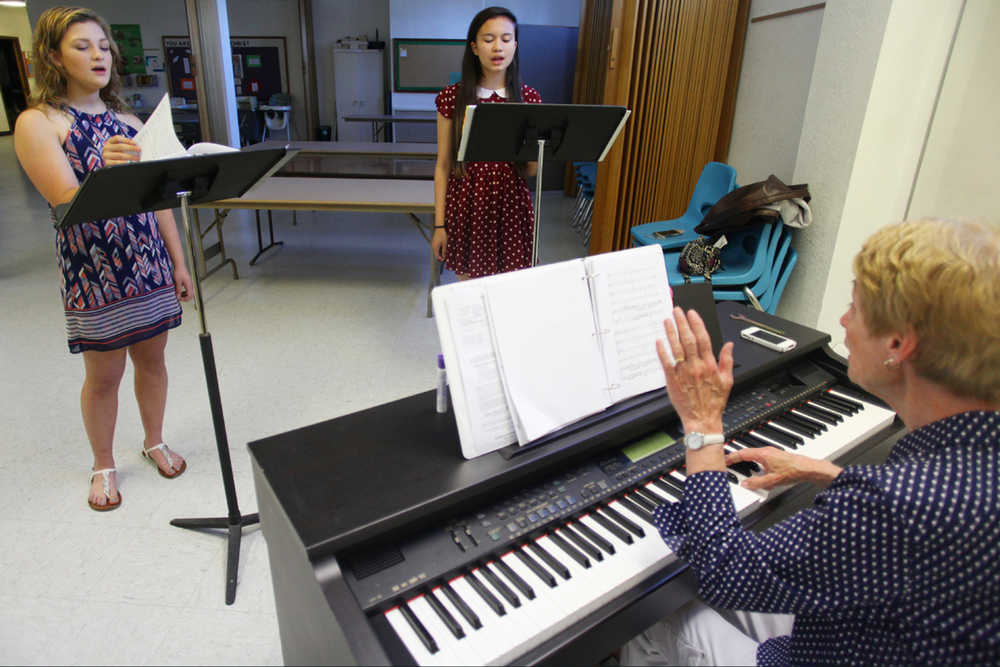 Photo by Kelly Sullivan/ Peninsula Clarion (Left) Nya Dukowitz, Candace Bowers and Rosemary Bird, music teacher at Kenai Middle School, prepare the two soon-to-be Kenai Central High School freshmen for the Let Freedom Sing Girlchoir National Convention on Tuesday, July 19, 2016 at Our Lady of Angels Catholic Church in Kenai, Alaska.