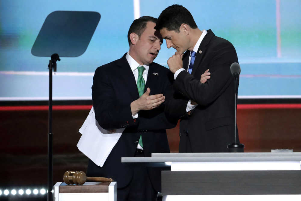 Speaker Paul Ryan of Wisconsin and Reince Priebus, Chairman of the Republican National Committee talk while Alaska recounts their votes during the second day of the Republican National Convention in Cleveland, Tuesday, July 19, 2016. (AP Photo/J. Scott Applewhite)