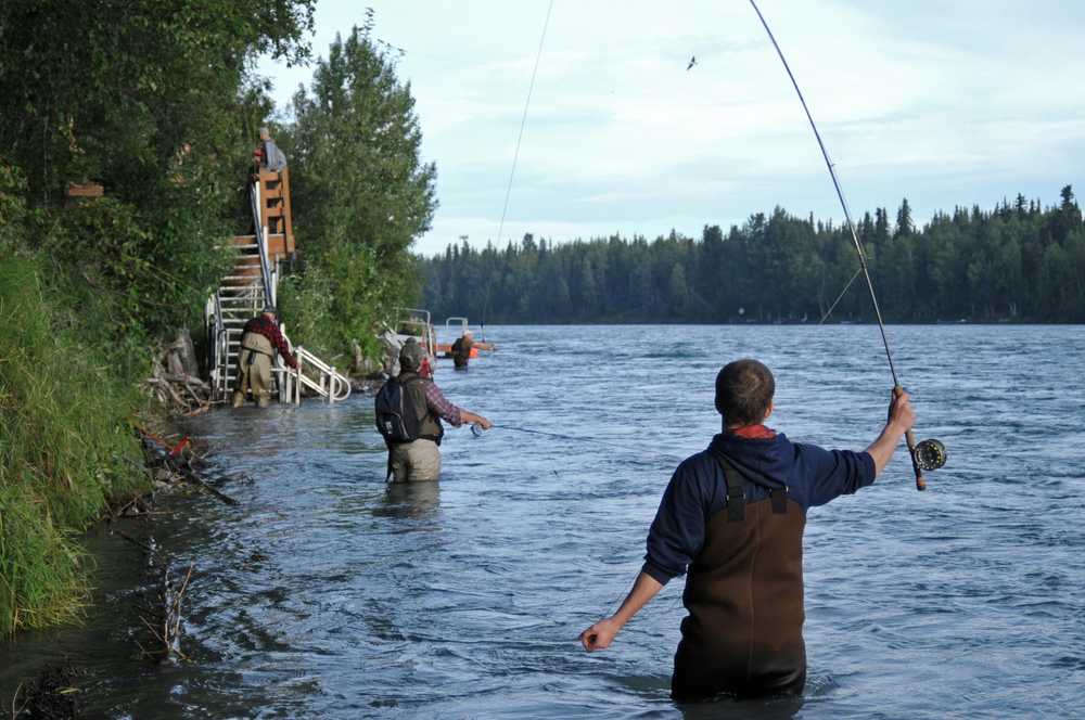 Photo by Elizabeth Earl/Peninsula Clarion Anglers cast along the banks of the Kenai River on Wednesday, July 20, 2016 in Soldotna, Alaska.