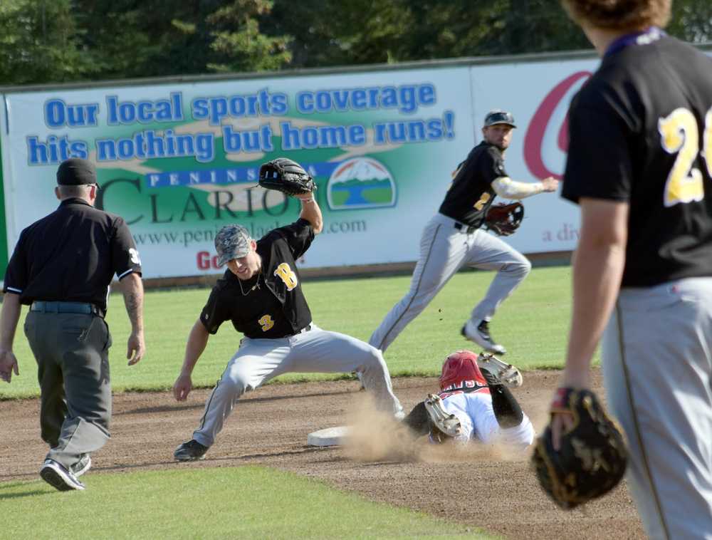 Photo by Jeff Helminiak/Peninsula Clarion Trey Dawson steals second base in front of Bucs second baseman Hunter Kasuls on Thursday at Coral Seymour Memorial Park in Kenai.