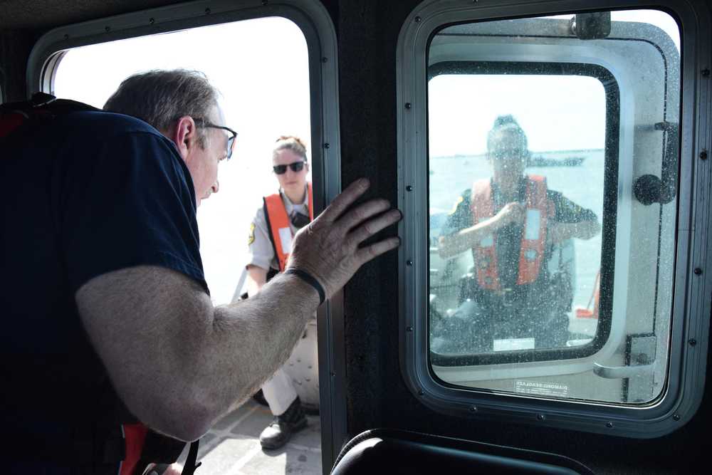 Photo by Megan Pacer/Peninsula Clarion Kenai Fire Battalion Chief Tony Prior checks in with Temporary Enforcement Officer Morgan Wensley and Kenai Police Officer Morgan Ezell during the first no-wake patrol of the personal-use dipnet season Tuesday, July 19, 2016 on the Kenai River. The fire and police departments work together to enforce the no-wake rules during high tides when banks are susceptible to erosion.