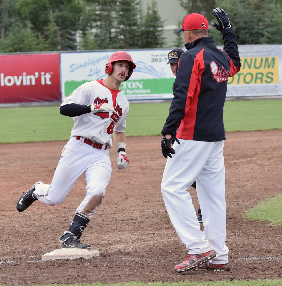 Photo by Jeff Helminiak/Peninsula Clarion Oilers second baseman Jeffrey Chapuran is congratulated by head coach Brian Daly after hitting a three-run home run in the bottom of the sixth inning  in Game 1 against the Anchorage Bucs on Sunday at Coral Seymour Memorial Park in Kenai.