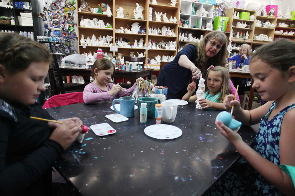 Photo by Kelly Sullivan/ Peninsula Clarion (Left to right) Anika Jedlika, Johana Jedlicka, store manager Tammy Bunn, Katy Cox, and Morgan Noyes dodged the heavy rain inside Cabin Fever Creations to celebrate Johana Jedlicka's 7th birthday Monday, July 25, 2016, in Soldotna, Alaska.