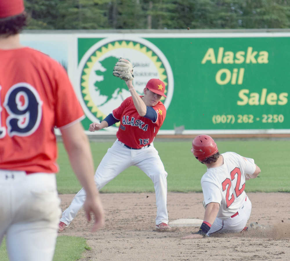 Photo by Jeff Helminiak/Peninsula Clarion Marshall Boggs of the Oilers steals a base in front of the tag of Goldpanners shortstop Tanner Negrette on Wednesday at Coral Seymour Memorial Park in Kenai.