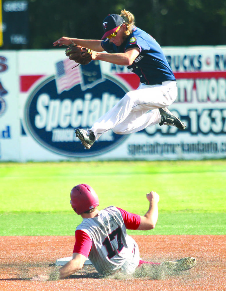 Kenai second baseman Jacob Sonnen leaps to grab a high throw as Wasilla's Koby Burns slides underneath into second safely durnig Kenai's win over Wasilla Thursday, July 28, 2016, the third day of the Alaska American Legion Baseball State Tournament at Mulcahy Stadium in Anchorage.