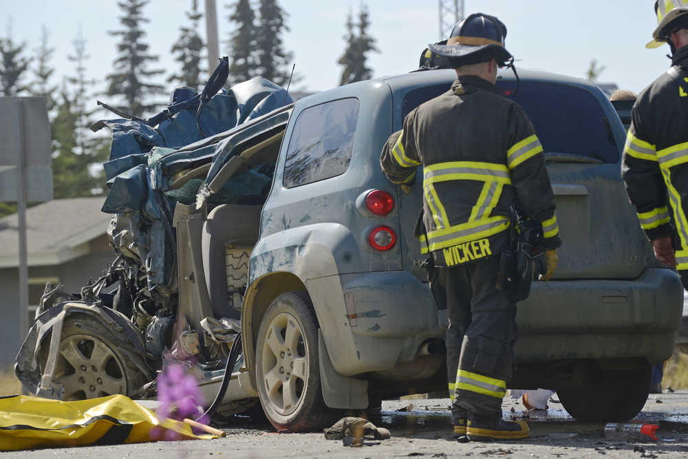 Ben Boettger/Peninsula Clarion Centrol Emergency Services personnel inspect a Chevrolet HHR that collided with a GMC Yukon on Kalifornsky Beach Road near Diamond M Ranch resort on Saturday, July 30 2016 near Kenai, Alaska. The drivers of the HHR and the Yukon were both killed and a female passenger in the Yukon was transported to Central Peninsula Hospital with injuries. Alaska Troopers on scene did not release the victims' names because their families hadn't yet been notified.