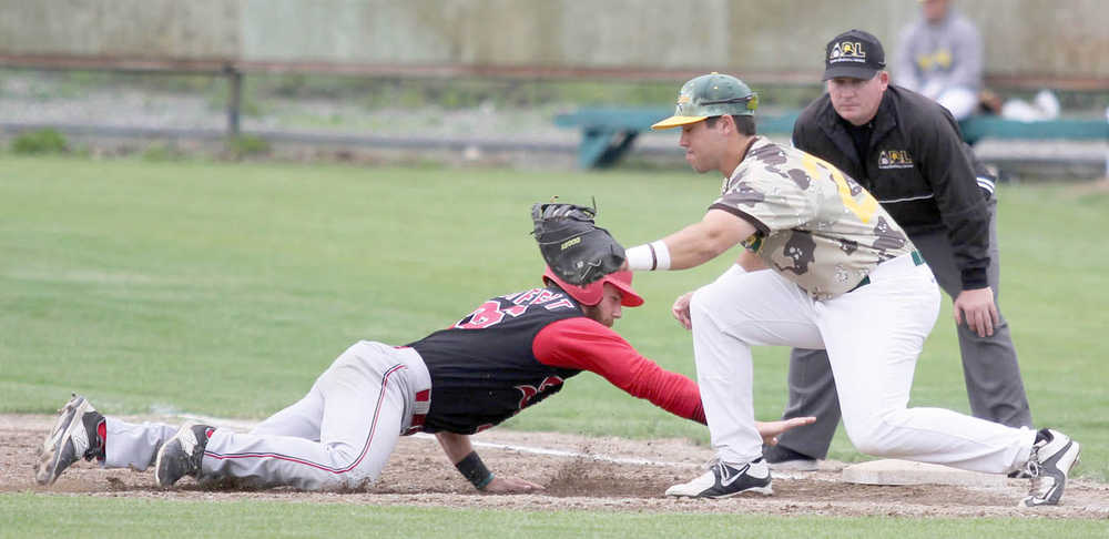 Peninsula Oilers infielder Alex Seifert slides back into first, under the tag of Mat-Su infielder Jake Scudder during a 2-1 victory over the Miners Saturday, July 30, 2016, at Hermon Brothers Field in Palmer.