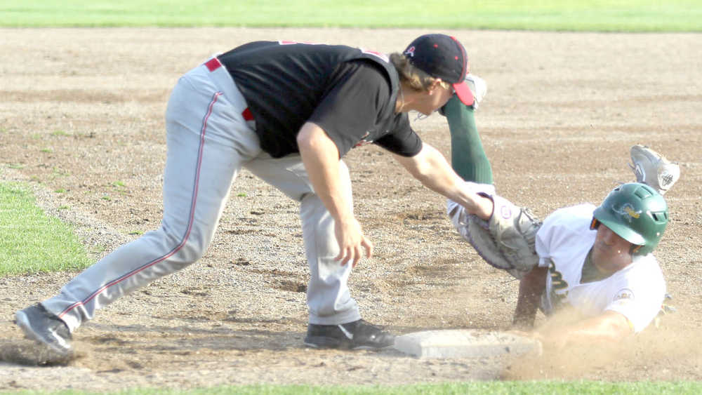 Peninsula first baseman Jonathon Washam tags Mat-Su's Angelo Armenta at first during a 3-2 win over the Miners Thursday, Aug. 3, 2016, at Hermon Brothers Field in Palmer. Armenta was ruled out on the play.