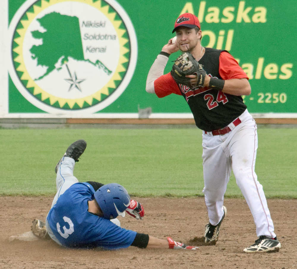 Photo by Jeff Helminiak/Peninsula Clarion Oilers shortstop Alex Seifert forces out Pilots center fielder Dalton Hurd on Friday in a first-round Top of the World Series game at Coral Seymour Memorial Park in Kenai.