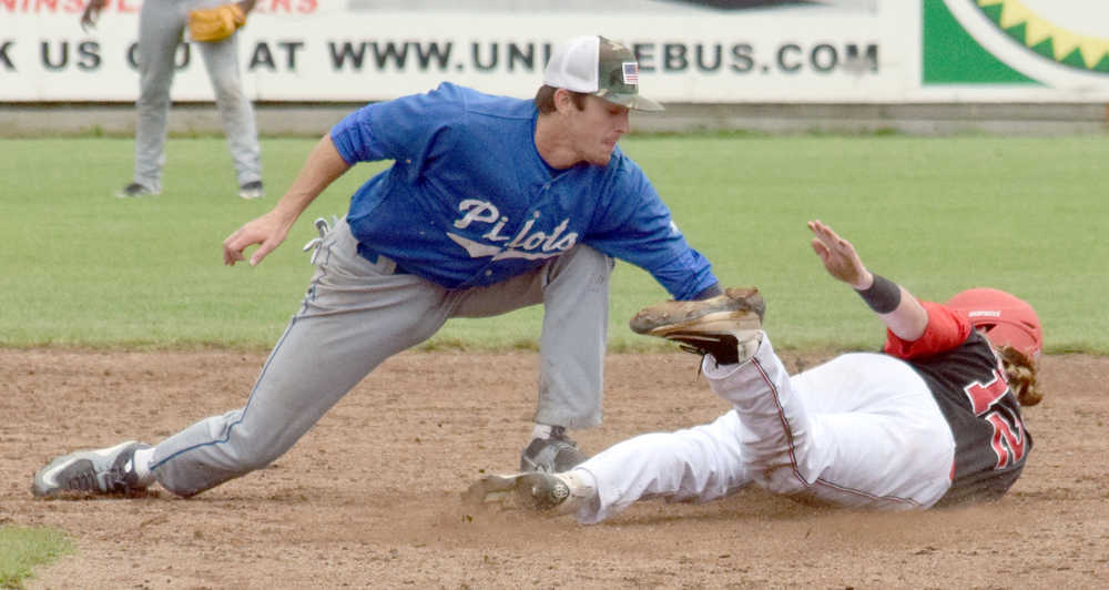 Photo by Jeff Helminiak/Peninsula Clarion Brody Wofford successfully steals second base in the seventh inning as Pilots shortstop Kyle Watson tries to tag him out Friday in a Top of the World Series semifinal at Coral Seymour Memorial Park in Kenai.