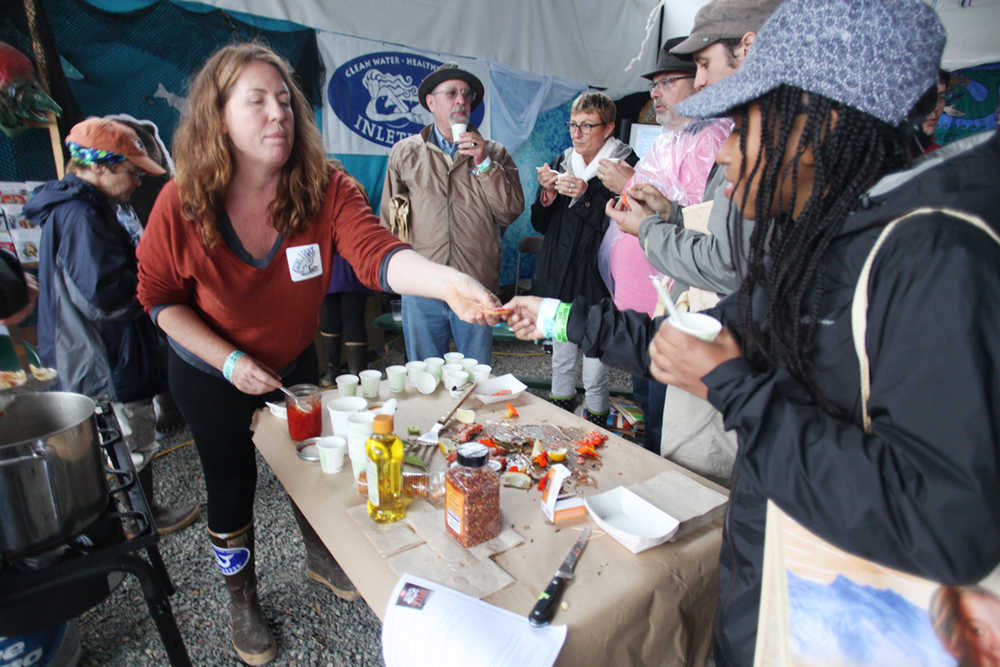 Green Dot Instructor Tara Schmidt, left, and Britni Seikanic, a Green Dot volunteer, make it rain Green Dots during Salmonfest, Aug. 5-7, 2016 in Ninilchik, Alaska. Homer representatives of Green Dot, a movement dedicated to ending violence in communities through the work of bystanders, had a booth at the festival for the first time.