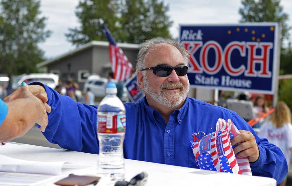 Ben Boettger/Peninsula Clarion  Alaska House of Representatives candidate and current Kenai City Manager Rick Koch shakes the hand of a parade judge at Soldotna's Progress Days on Saturday, July 23. Koch will compete for the Republican District 30 State House nomination in the party primary on August 16.