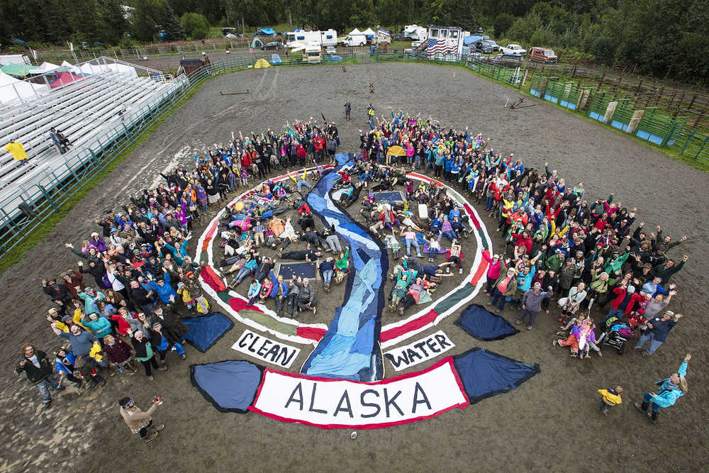 Photo by Paul Scannell/courtesy Mavis Muller Hundreds of Salmonfest participants braved the rainy conditions on Saturday, Aug. 6, 2016 in Ninilchik, Alaska to send a clear message of support and solidarity for clean water and for wild Alaskan salmon with an aerial group photo which was lead by Homer artist Mavis Muller. A circular design created with recycled fabric depicted a river flowing through a yin yang design. A procession of colorful percussion performers and a Chinese dragon-style salmon puppet named Queen Marine moved up and back down the fabric river. All participants merged into the fabric river behind the puppet as they exited the rodeo arena and joined a parade that moved through the festival grounds. Muller also lead the construction of the puppet and the handmade percussion instruments. "Art is communication," Muller explained. "With our creativity we can heighten awareness. We can inspire new possibilities and have fun doing it."