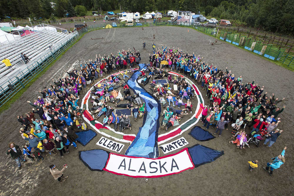 Photo by Paul Scannell/courtesy Mavis Muller Hundreds of Salmonfest participants braved the rainy conditions on Saturday, Aug. 6, 2016 in Ninilchik, Alaska to send a clear message of support and solidarity for clean water and for wild Alaskan salmon with an aerial group photo which was lead by Homer artist Mavis Muller. A circular design created with recycled fabric depicted a river flowing through a yin yang design. A procession of colorful percussion performers and a Chinese dragon-style salmon puppet named Queen Marine moved up and back down the fabric river. All participants merged into the fabric river behind the puppet as they exited the rodeo arena and joined a parade that moved through the festival grounds. Muller also lead the construction of the puppet and the handmade percussion instruments. "Art is communication," Muller explained. "With our creativity we can heighten awareness. We can inspire new possibilities and have fun doing it."