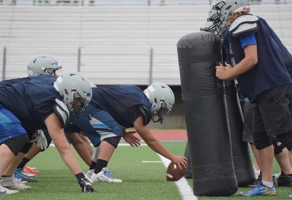 Photo by Joey Klecka/Peninsula Clarion Soldotna center Alex Goodermote prepares to snap the ball Wednesday during practice at Justin Maile Field in Soldotna.