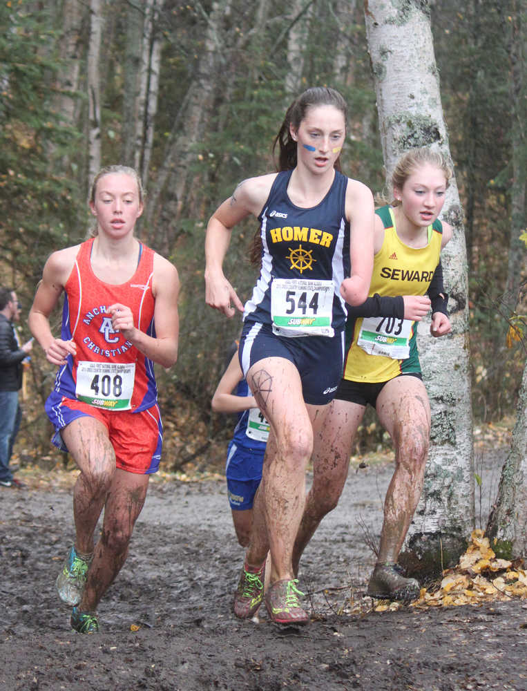 Photo by Joey Klecka/Peninsula Clarion Homer runner Megan Pitzman (544) races with Seward's Ruby Lindquist (703) and ACS's Elizabeth Balsan (408) Oct. 3, 2015, at the Class 1-2-3A state cross-country running championships on the Bartlett High School trails.