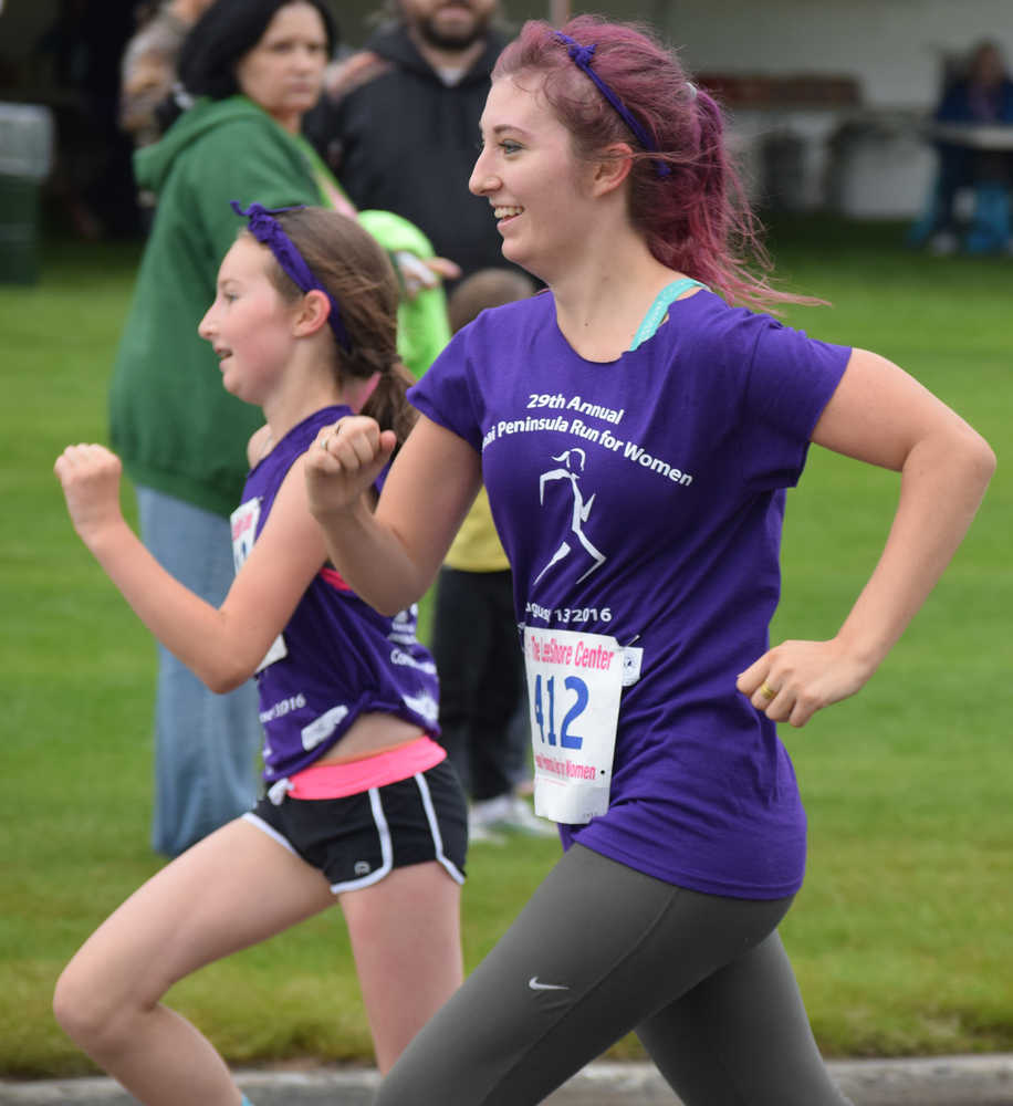 Photo by Joey Klecka/Peninsula Clarion Jacynne Collver (412) runs side by side with Luthien Collver in Saturday's Run for Women 5K race in Kenai.