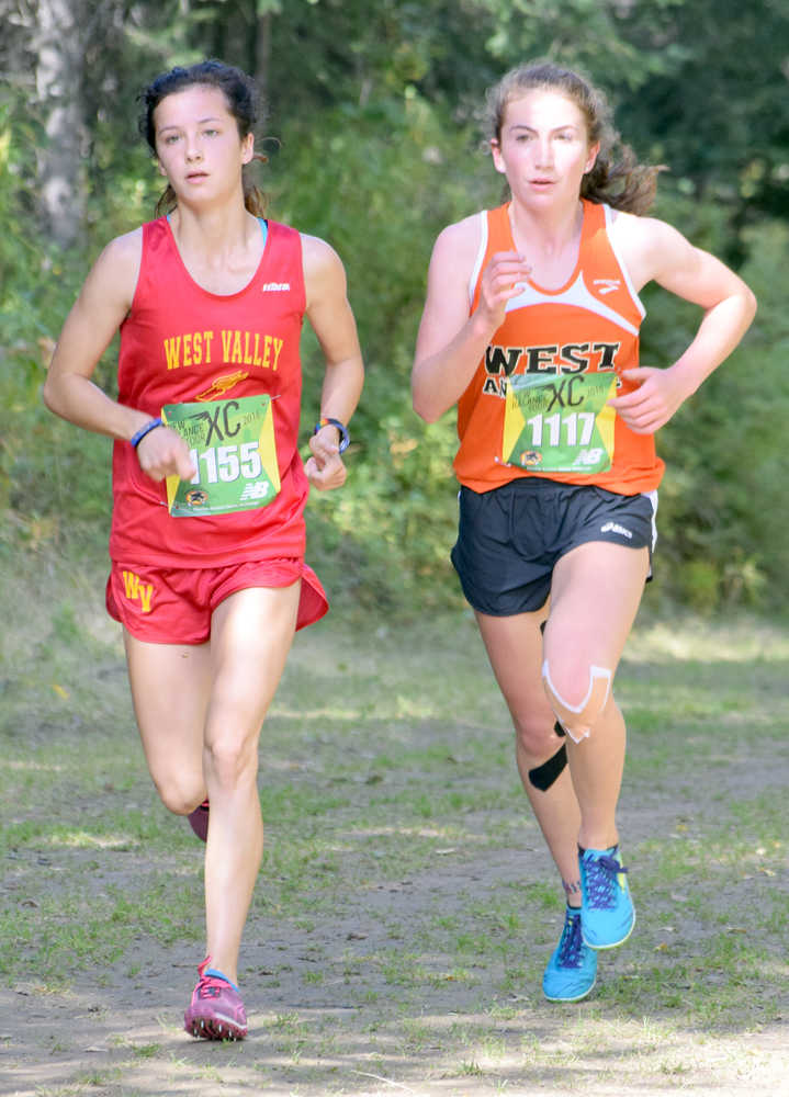 Photo by Jeff Helminiak/Peninsula Clarion West Valley's Kendall Kramer and West's Molly Gellert run together just over two kilometers into the Tsalteshi Invitational at Tsalteshi Trails on Saturday. Kramer would pull away from Gellert for the victory.