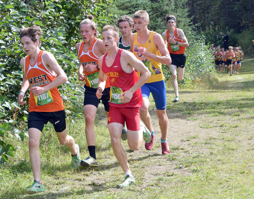 Photo by Jeff Helminiak/Peninsula Clarion West's Finn Walker pulls the lead pack away from the field about halfway through the Tsalteshi Invitational at Tsalteshi Trails on Saturday.