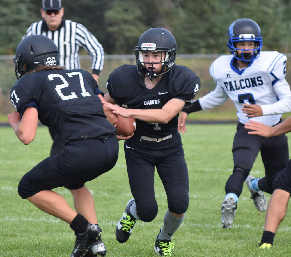 Photo by Joey Klecka/Peninsula Clarion Nikiski sophomore Kameron Maxie looks upfield after an interception on Thunder Mountain quarterback Cale Jenkins in the second half Saturday at Nikiski.