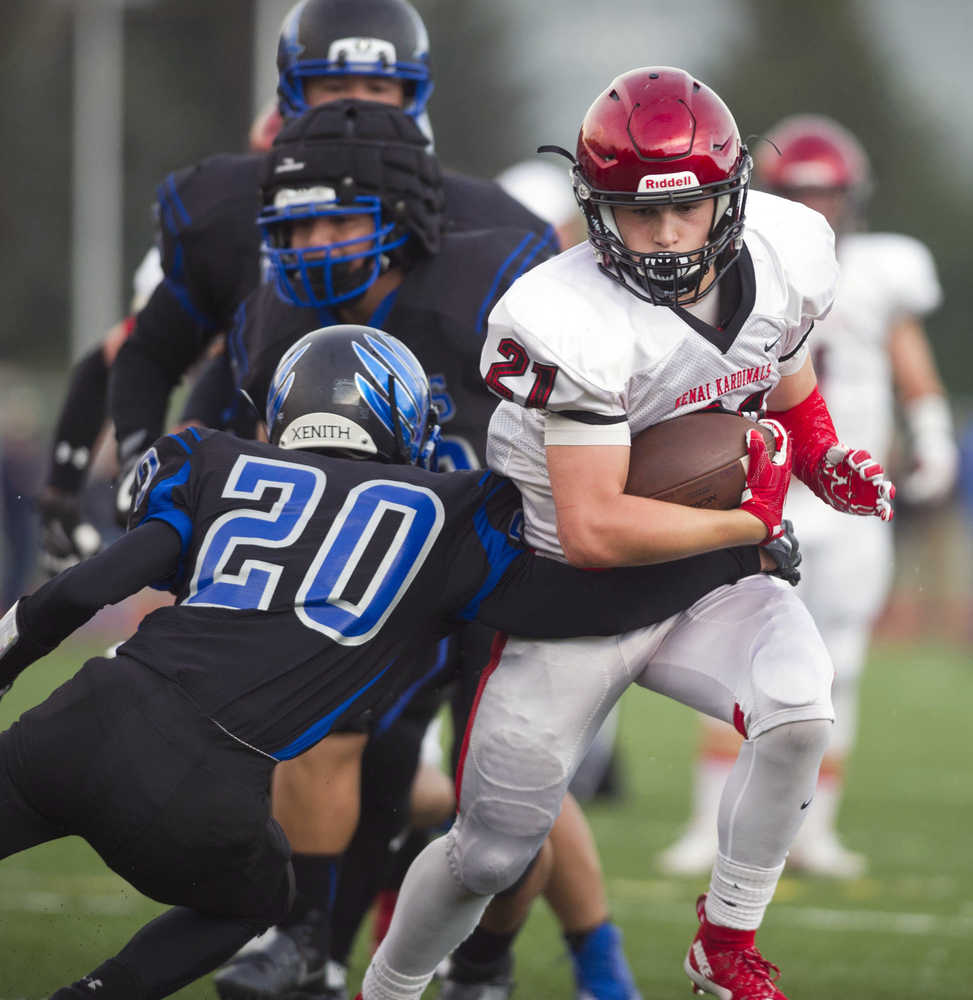 Kenai's Zack Tuttle, right, breaks a tackle by Thunder Mountain's Jacab Tapia at TMHS on Friday. Kenai won the game 23-12.