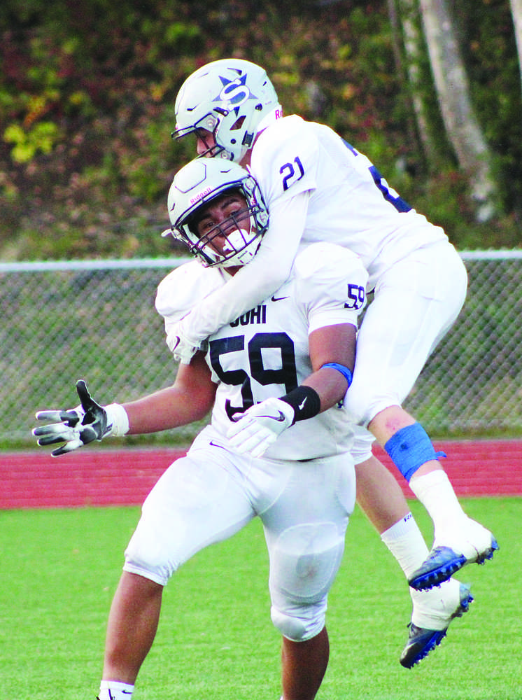 Soldotna linebacker Wendell Tuisala celebrates a first-half safety with teammate Levi Hensley Friday night. (MATT HICKMAN/Frontiersman)