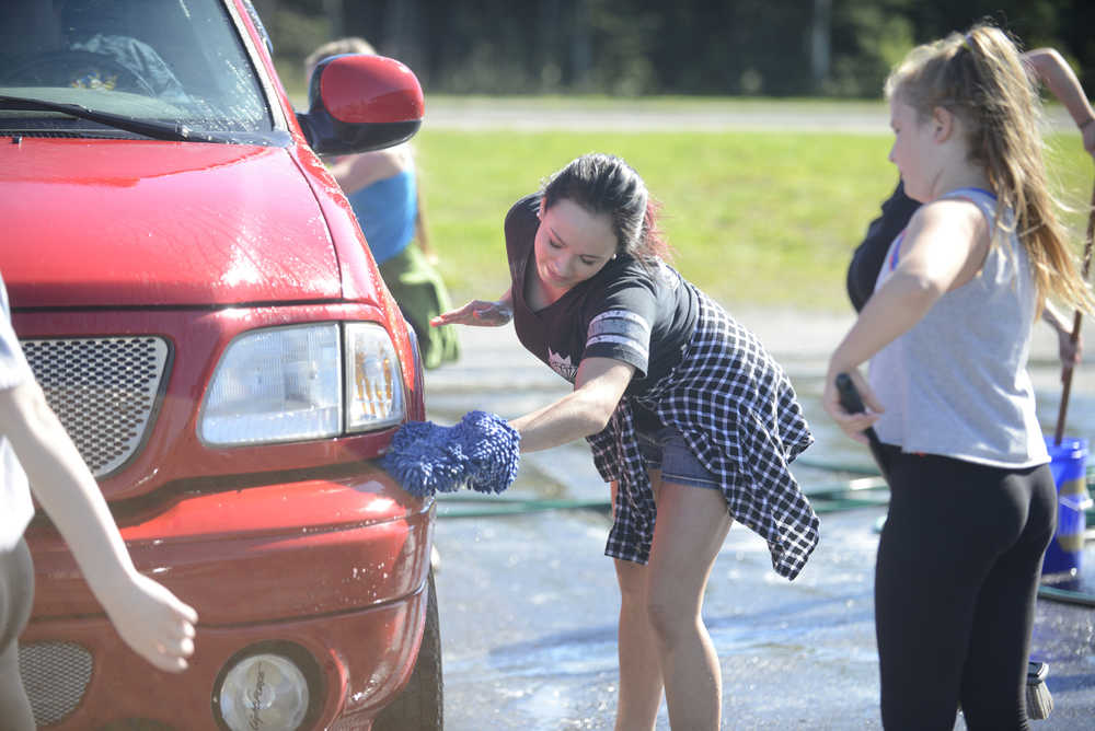 Photo by Kelly Sullivan/ Peninsula Clarion (Left) Kiana Dalton and Kennedy Whitney work on a Kenai Fire Department vehicle for the Diamond Dance Project fundraiser carwash Sunday, Aug. 28, 2016 in Kenai, Alaska.