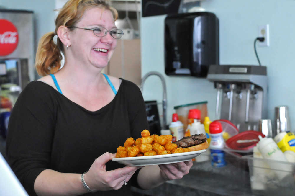 Samantha Nushart, an employee at Double O Express, holds a complete order at the restaurant on Tuesday, Aug. 23, 2016 in Kenai, Alaska. The restaurant recently moved from its old location next to the Bow Bar in Old Town Kenai to a brick-and-mortar location in the Kenai Airport that used to house Odie's Deli.