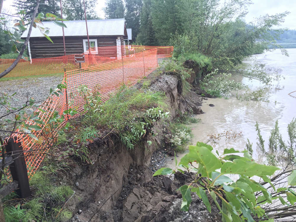 This July, 2016, photo, provided by Alaska State Parks, shows an old cabin at Big Delta State Historical Park 90 miles southeast of Fairbanks, Alaska, that was recently moved back 50 feet because of an eroding riverbank. The Alaska State Parks agency is turning to crowdfunding to raise money for erosion protection at the park. (Brooks Ludwig/Alaska State Parks via AP)