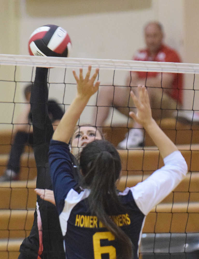 Photo by Joey Klecka/Peninsula Clarion Kenai Central senior Abby Beck spikes the ball against a Homer player Tuesday at Cliff Massie court in Kenai.