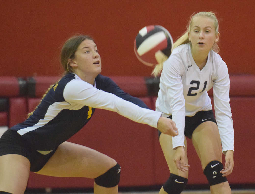 Photo by Joey Klecka/Peninsula Clarion Homer senior MaryHana Bowe digs a serve from Kenai Central Tuesday at Cliff Massie Court in Kenai while teammate Izabelle Hagge (21) looks on.