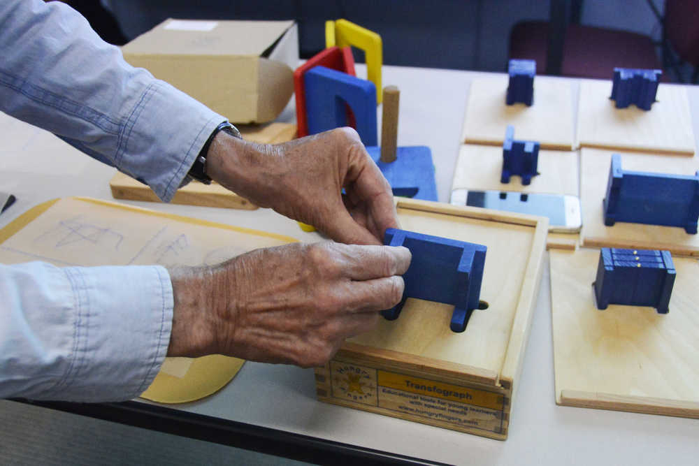 Photo by Megan Pacer/Peninsula Clarion Jordana Engebresten, teacher for visually impaired and blind students for the Kenai Peninsula School District, explores the transfograf, a tool developed to help blind students understand how objects are transfered to drawings, during a workshop Tuesday, Sept. 1, 2016 at Soldotna Prep in Soldotna, Alaska. The tool, along with several others, was developed by Boguslaw "Bob" Marek, a professor of English from Poland who shared the resources in Anchorage and Soldotna this month.