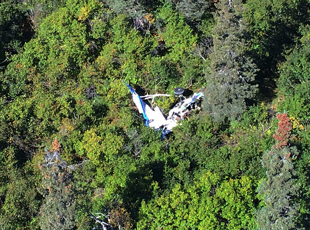 This Wednesday, Aug. 31, 2016, photo provided by Alaska State Troopers, shows the wreckage of a Piper Super Cub involved in a deadly midair collision with another small plane over a remote area near the village of Russian Mission in western Alaska. A total of five people died in the Wednesday morning crash. Rough terrain complicated efforts to recover the bodies of the four Alaskans and a Montana man who died. (Alaska State Troopers via AP)