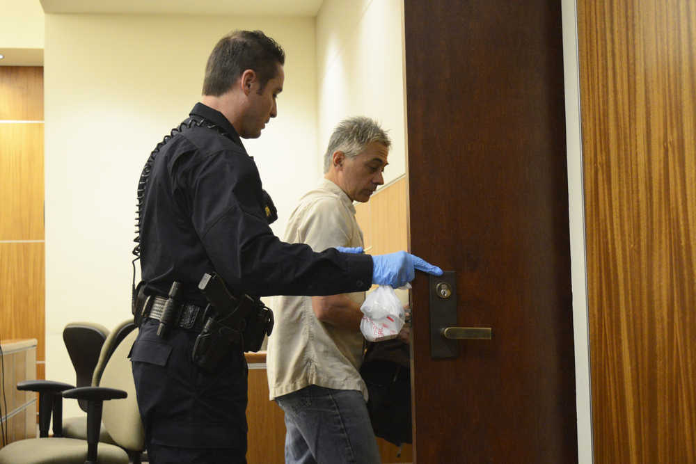 Photo by Megan Pacer/Peninsula Clarion Michael Dean Hancock is led out of the courtroom Friday, Sept. 2, 2016 at after his change of plea hearing at the Kenai Courthouse.  The former Soldotna area karate teacher pleaded guilty to second degree sexual abuse of a minor and unlawful exploitation of a minor in a plea agreement tied to his case in Anchorage, where he faces charges of child pornography.