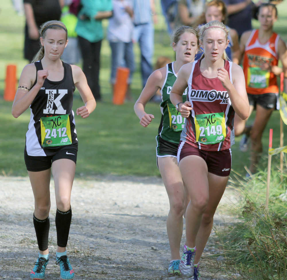 Kenai Central's Jaycie Calvert runs alongside athletes from Dimond and Colony during the 4A girls' race of the Palmer Invitational Saturday, Sept. 3, 2016, in Palmer. Calvert finished 10th in the race.