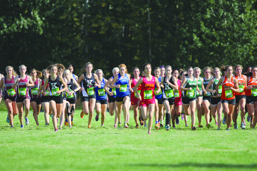 A pack of runners leaves the start at the beginning of the 4A girls' race during the Palmer Invitational Saturday, Sept. 3, 2016, at Palmer High School. More than 1,000 athletes competed in the meet, which included junior varsity and varsity races in both the small and large-schools classes. For more, see frontiersman.com/sports and the Wednesday edition of the Frontiersman.