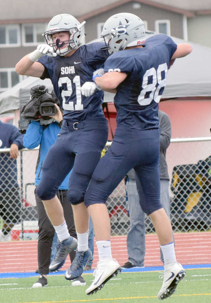 Photo by Jeff Helminiak/Peninsula Clarion Soldotna's Levi Hensley and Andy West celebrate West's touchdown against West Anchorage on Aug. 12 at Justin Maile Field in Soldotna.