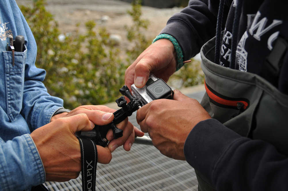 Photo by Elizabeth Earl/Peninsula Clarion Cook Inlet Aquaculture Association Executive Director Gary Fandrei (left) and biologist Rodney Hobby (right) adjust a GoPro camera to film a possible leak beneath the Paint River fish ladder Friday, Sept. 2, 2016 on the Paint River near the McNeil River State Game Sanctuary and Refuge, Alaska. Cook Inlet Aquaculture Association operates the fish ladder to allow salmon to pass into the upper reaches of the remote river system to spawn.
